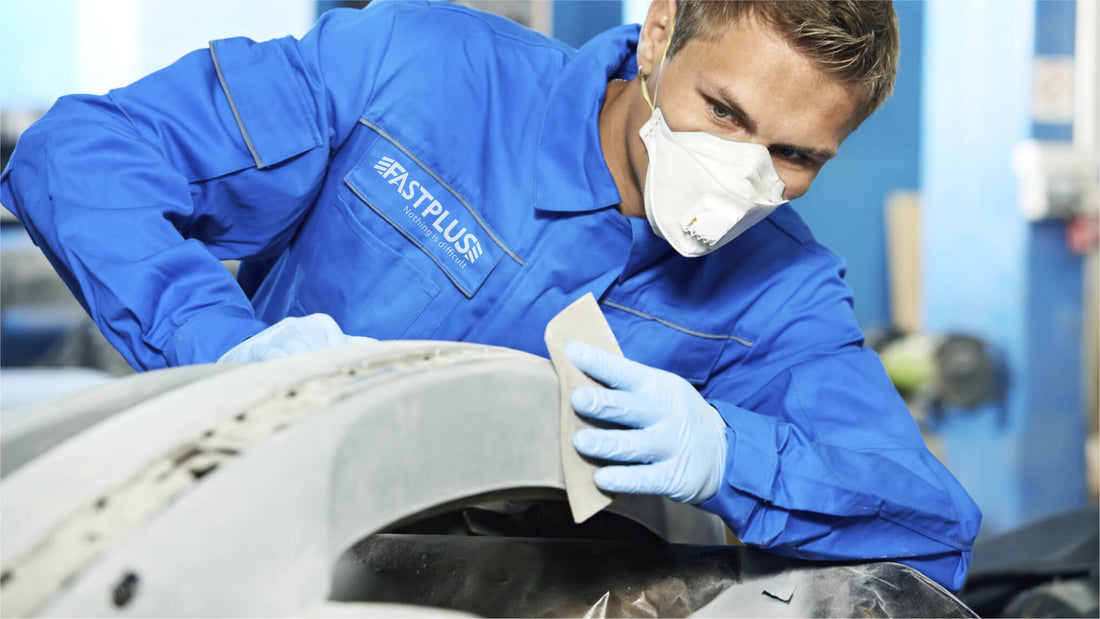Ein Mann schleift Kunststoffteile eines Autos mit Fastplus-Schleifpapier A man is sanding plastic parts of car with fastplus sandpapers