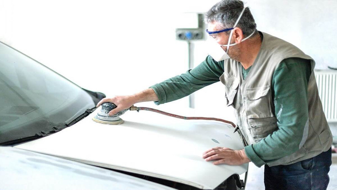 Sanding the car surface using an orbital sander