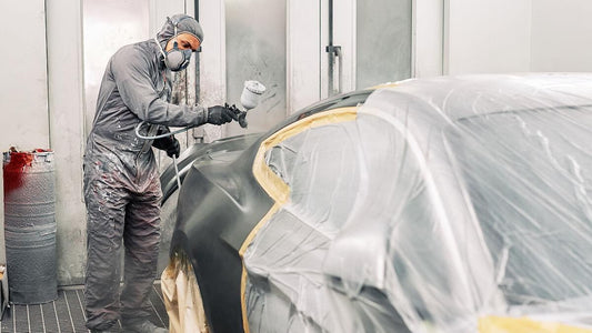 A painter is painting the car