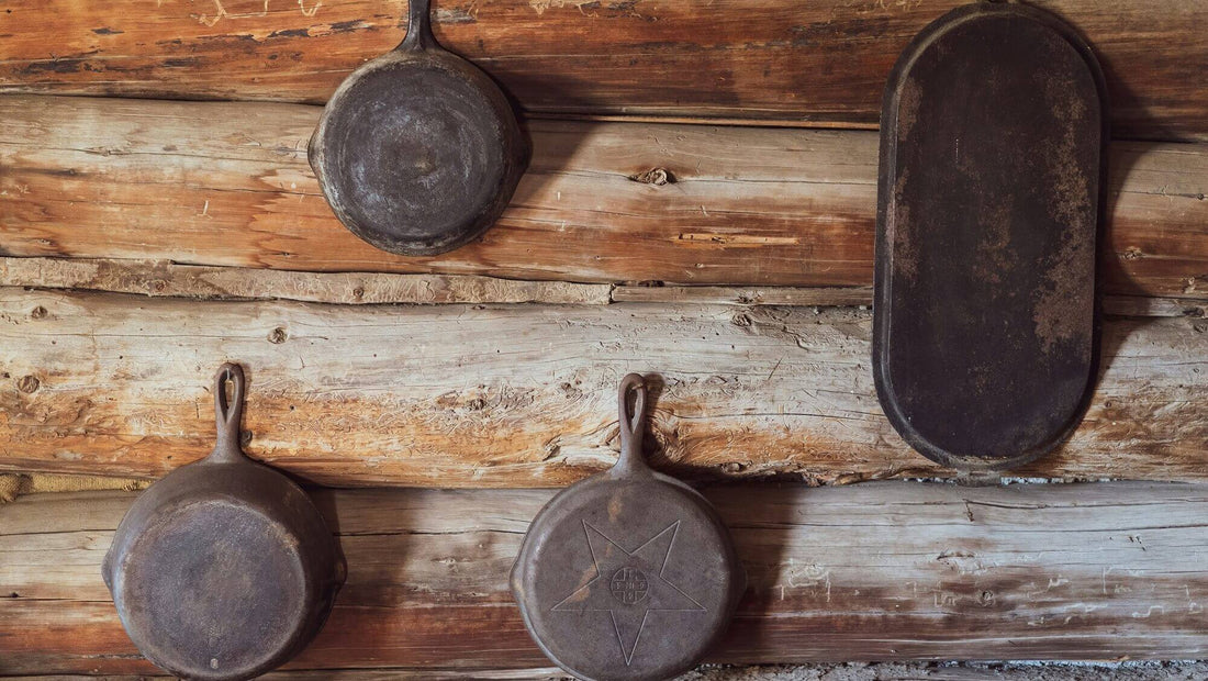 Rusted cast iron skillets on the wooden wall